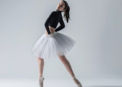 Photo that shows ballet dancer posing; demo of dance class in NYC area
